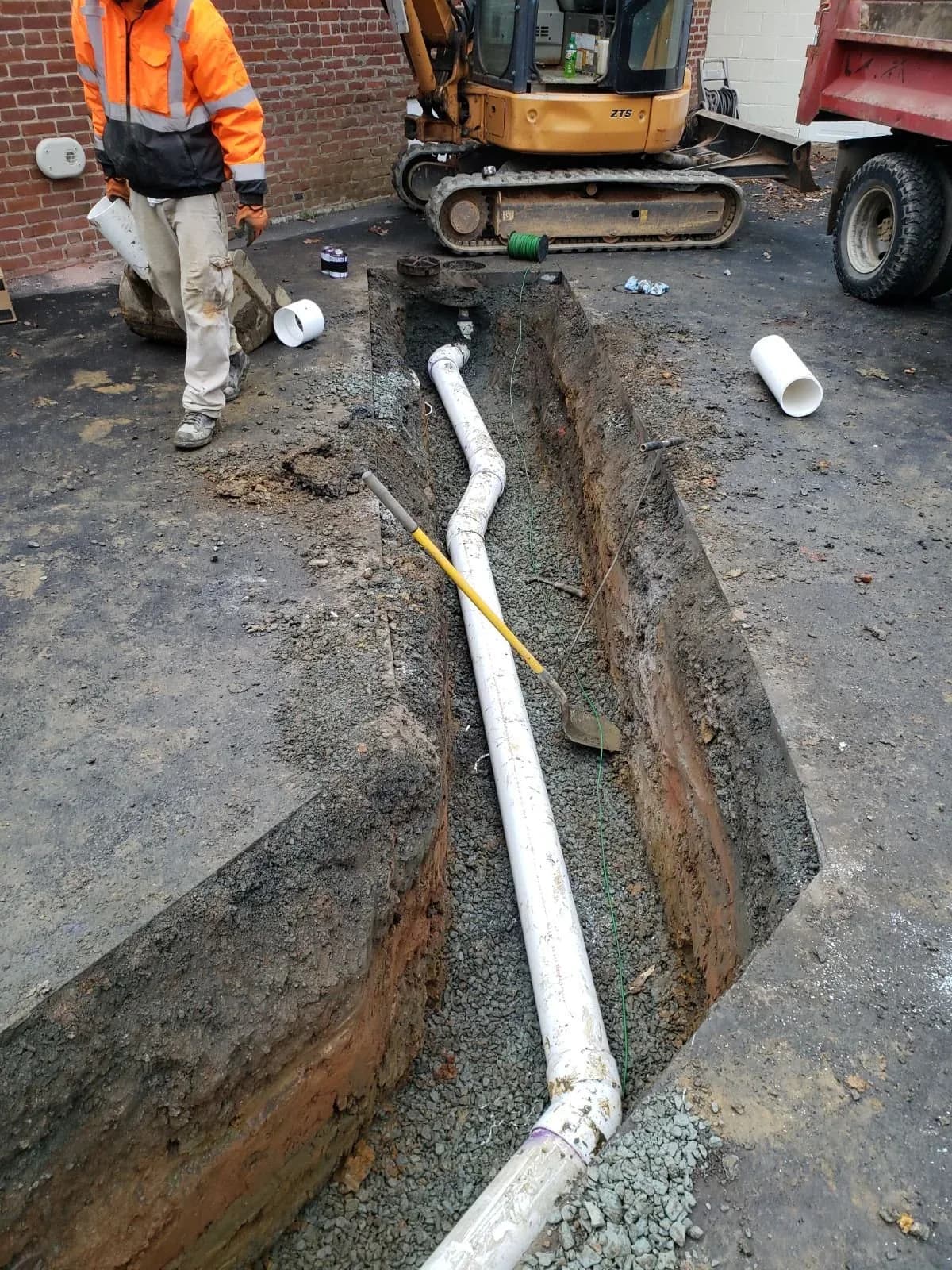 Sewer line installation through asphalt paving at a commercial property in Central Virginia